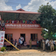 People seek shade by the Communist coalition office while they wait for Priyanka Gandhi’s address.